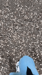 Woman walks waterfront, picks up object in Budva Montenegro