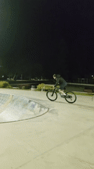 Mountain biker navigates skate park features in Dobrich