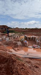 Open-pit mining work underway in Jos, Nigeria's red-earth terrain