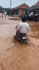 Flooding and street life in Ihiagwa, Nigeria
