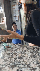 Woman observed in small bar or bodega setting
