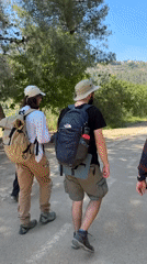 Hikers with dog walk rural Israel paths Friday morning
