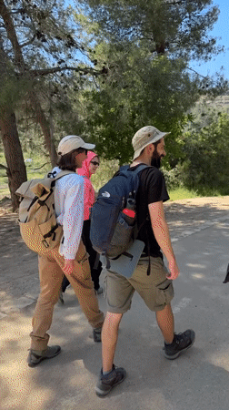 Hikers with dog walk rural Israel paths Friday morning