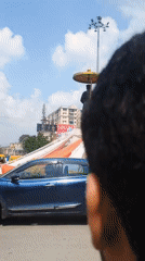 Morning street activity around a busy Varanasi urban corridor