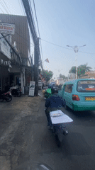 Morning motorcycle commute through East Jakarta traffic