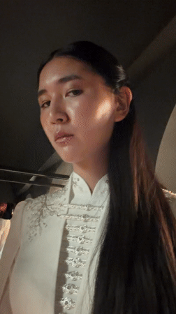 Woman poses for portrait in ornate jacket, Paris