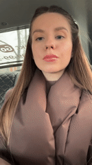 Woman applies makeup, takes selfie in car in Klin