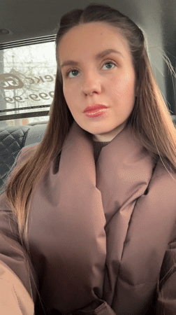 Woman applies makeup, takes selfie in car in Klin
