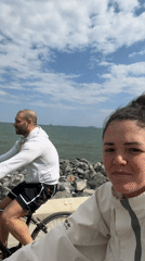 Cyclists ride along Burgas coast, woman films coastal bike ride