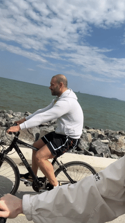 Cyclists ride along Burgas coast, woman films coastal bike ride