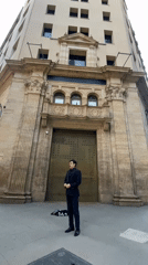 Man in suit performs street singing near Buenos Aires landmarks