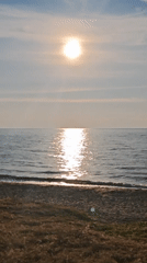 Peaceful moments captured: beach tranquility and woman with smartphone