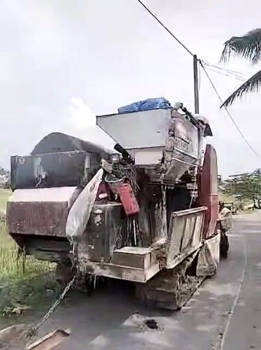 Combine harvester parked roadside in Dayahbaro, Indonesia