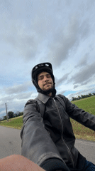 Cyclist rides through rural Italian countryside near Gudo Visconti