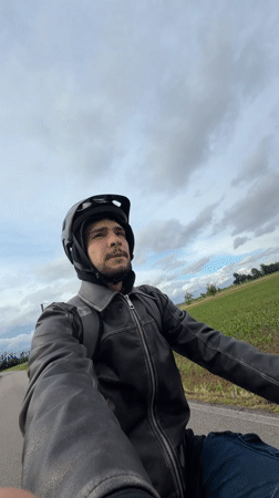 Cyclist rides through rural Italian countryside near Gudo Visconti