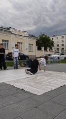 Breakdancer mid-inversion at an outdoor performance in Yekaterinburg
