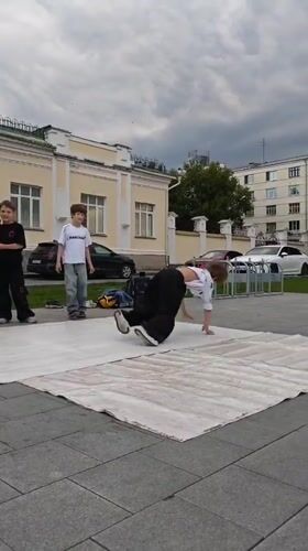 Breakdancer mid-inversion at an outdoor performance in Yekaterinburg