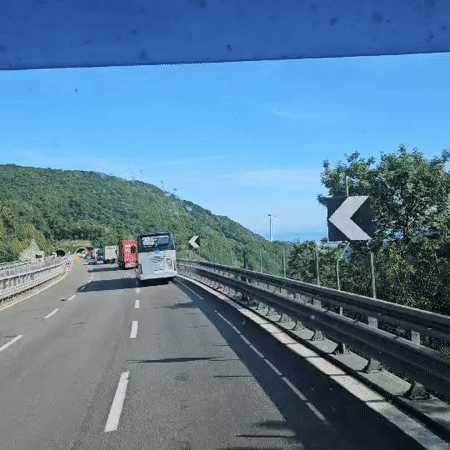 Highway travel captured near Mele, Italy on clear day