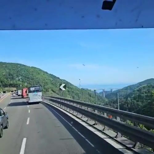 Highway travel captured near Mele, Italy on clear day