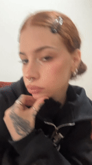 Red-haired woman in black hoodie photographed in Buenos Aires