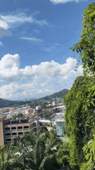 Hillside view over Ratsada town and distant mountains