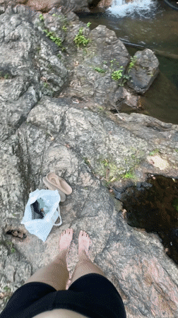 Tourist photographs waterfall in Ko Samui, Thailand