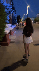Woman skateboards, dines in Krasnoyarsk during evening hours