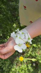 Child and adult craft flower bracelets outdoors in Russia