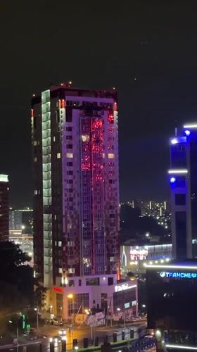 Colorful building lights illuminate Khabarovsk cityscape at night