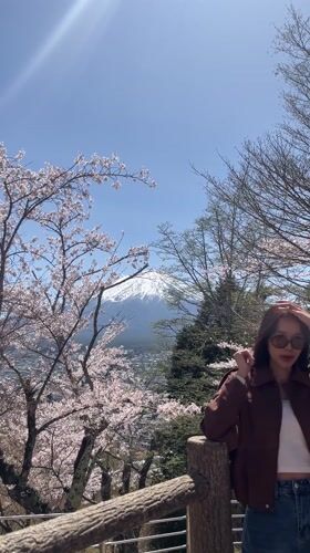 Tourists gather in Fujiyoshida for Mount Fuji cherry blossom viewing