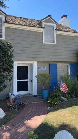 Gray two-story house with open front door, Long Beach