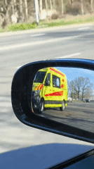 Emergency ambulance passes vehicle in morning Riga traffic