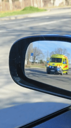 Emergency ambulance passes vehicle in morning Riga traffic