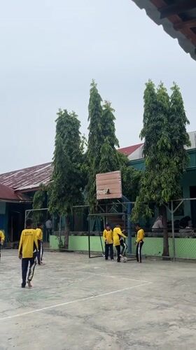 Outdoor school PE session in Lhokseumawe, soccer and group exercises.