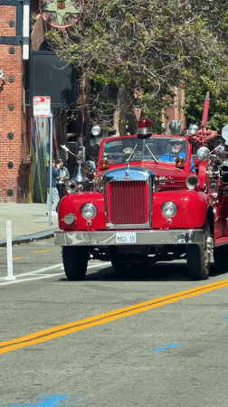 Vintage Mack fire truck cruising through San Francisco streets