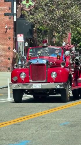 Vintage Mack fire truck cruising through San Francisco streets