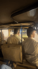 Two men ride auto-rickshaw through Quetta at night