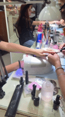 Woman gets black manicure at Mexican nail salon