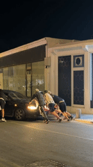 Evening street activities in Paphos: car push, scooter tricks