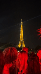Nighttime party with DJ draws crowds near illuminated Eiffel Tower