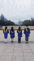 Graduates celebrate in blue gowns at Chongqing campus