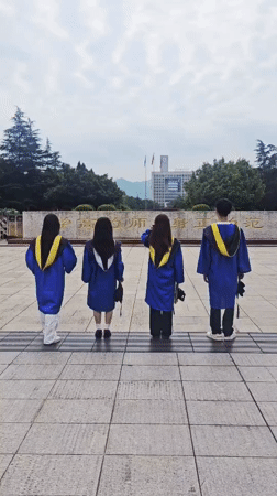 Graduates celebrate in blue gowns at Chongqing campus