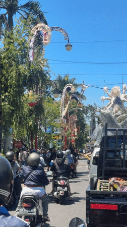 Morning traffic flows through decorated streets in Gianyar, Indonesia