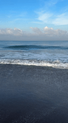 Evening beach scene captured on black sand in Kediri