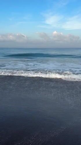 Evening beach scene captured on black sand in Kediri