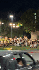 Large group gathers in Córdoba park at night