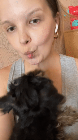 Cozy indoor selfies with a small black and tan puppy