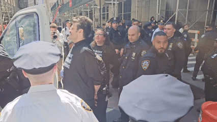 Police escort two civilians on NYC street