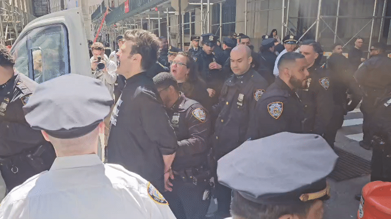 Police escort two civilians on NYC street