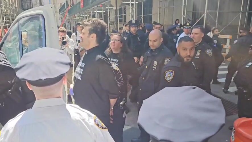 Police escort two civilians on NYC street